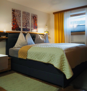 Cozy bedroom with large pillows, modern bed, and warm colors in Bruckberg.